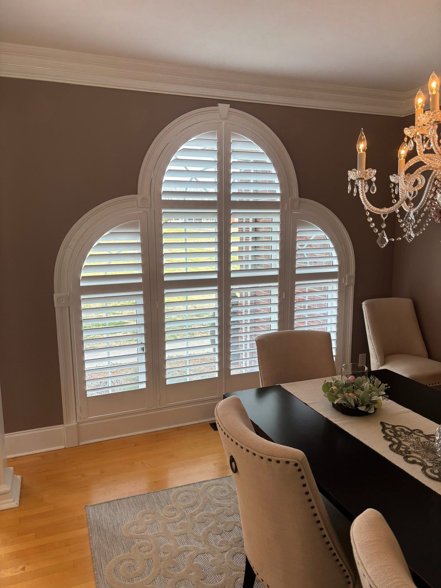 Shutters fitted to an arched dining room window