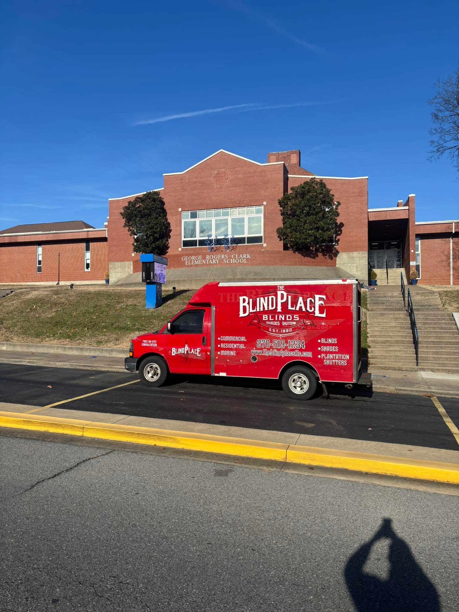 The Blind Place van outside a brick commercial building