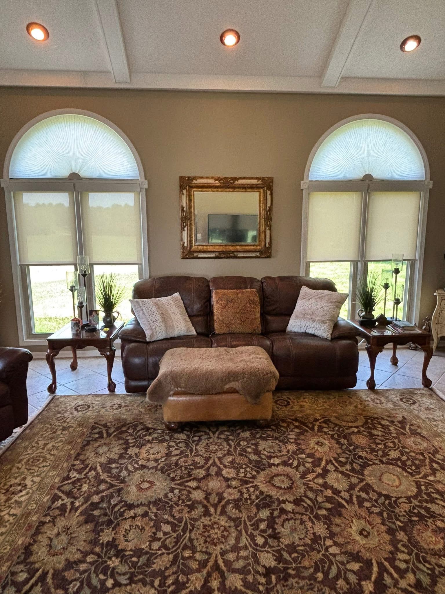 Shades fitted to arched living room windows