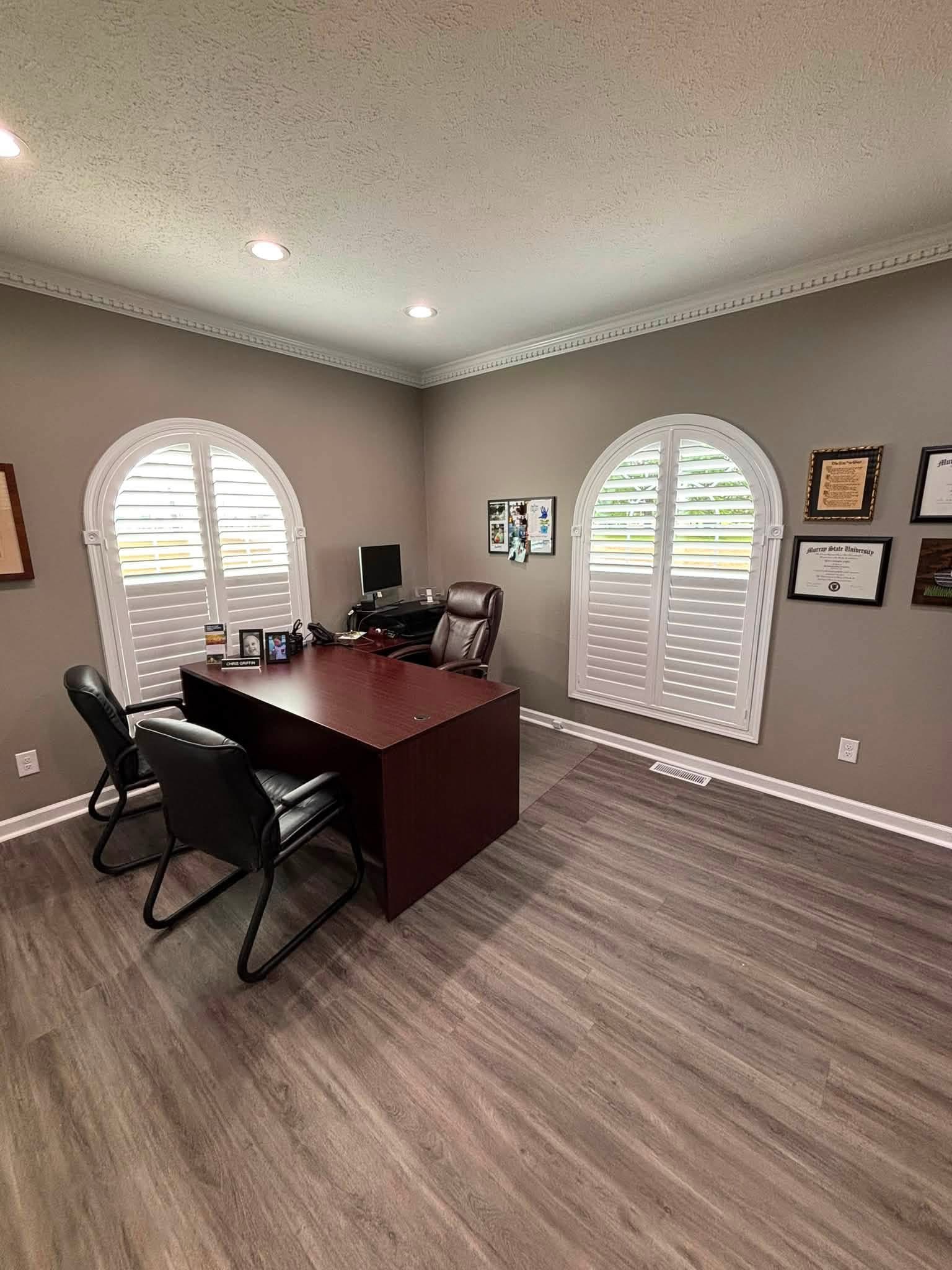 White shutters in an office with arched windows